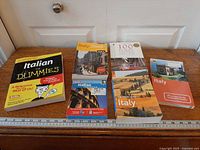 All six Italian language and travel books displayed together with ruler for scale