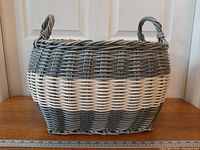 Front view of resin woven basket showing colour pattern and handles