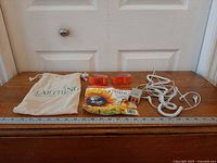 Full kit laid out: bag, two bands, booklet, tester, cords