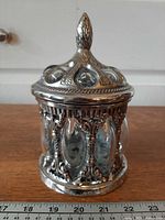 Full view of jar with lid showing metal frame and bubble glass