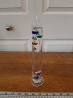 Front view of full thermometer showing colored bulbs and scale for height