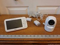 Entire system laid out: parent unit, camera, two adapters and cords with ruler for scale