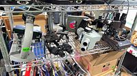 Full shelf view showing microscopes, power box, brackets and binoculars
