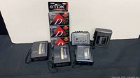 Group shot of five cassette players and four sealed TDK tapes