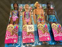 All four sealed Barbie and Ken beach dolls