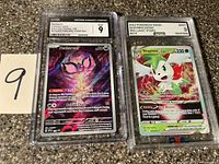 Both graded cards in slabs side by side