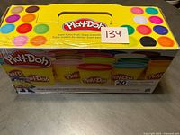 Front view of unopened Play-Doh 20 Color Pack showing damaged box