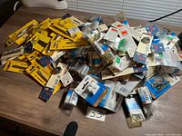 Pile of assorted sealed hardware packs on tabletop