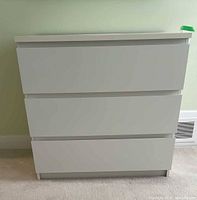 Front view of dresser showing three drawers closed