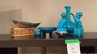 Front view of all nine decor pieces displayed on shelf