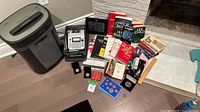 Overall lot showing shredder, label maker, books, coins