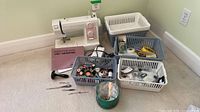 Overall lot showing sewing machine and baskets of supplies
