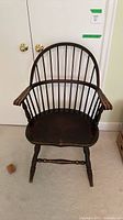 Front view of Windsor armchair showing hoop back, spindles, arms, seat and legs