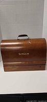 Closed bentwood Singer case front view