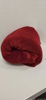 Rolled red Pottery Barn fleece blanket