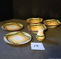 Overall view of three bowls, two plates, salt shaker