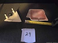 Overview of both ashtrays with tape measure for scale