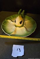 Leaf-shaped platter with fish holder inserted, tape for scale