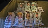 Front view of seven sealed Madame Alexander Happy Meal dolls