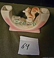 Front view showing entire ceramic double vase with squirrel figurine