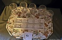 5 holiday tumblers, 2 boxes of jeweled place card holders, 4 placemats beneath