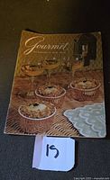Front cover showing title Gourmet and food vignette
