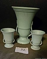 Front view of three pale green Haeger urn vases
