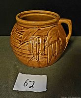 Front view of brown McCoy bean pot with pea pod relief