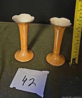 Front view of both matching vases showing color, shape and scale with tape measure