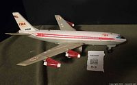 Left side view of TWA Boeing 707 tin toy showing fuselage graphics and landing gear