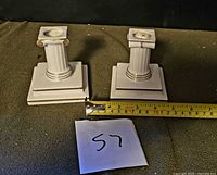 Pair of Vista Alegre porcelain ionic candlesticks with measuring tape for scale