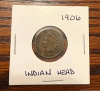 Obverse view of 1906 Indian Head cent in cardboard 2x2 holder