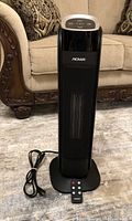 Front view of NOMA tower heater with remote and power cord
