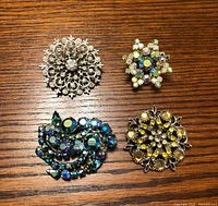 Group shot of all four rhinestone brooches