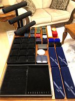 Overall view of trays, stands, long cases and smaller boxes on table