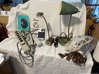 Group shot showing both lamps, power strips, cords, mouse, cable clip, radio, adapter