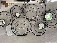 Front view of one mirror showing concentric ring design and mirrors