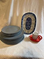 Stack of IKEA plates, oval platter, espresso cup with saucer
