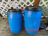 Both blue barrels side by side showing size and lids