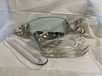 Fish platter, stack of glass corn dishes, and metal bowl overview