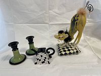 Full lot showing teapot, cat figurine and two candlesticks