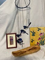 Group shot showing wind chime, wooden bowl, hummingbird picture, small framed artwork