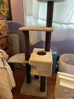 Full view of cat tree showing base, cubby, posts, and platforms