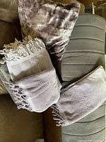 Stacked Turkish towels and foam mat on sofa