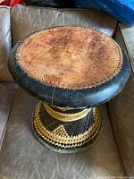 Top view of leather seat showing hand-laced edge and wear