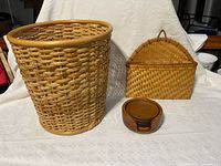 All three items: woven wastebasket, wall basket, teak coaster set