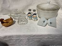 Full lot overview showing casserole, milk glass bowls, clear glass covered dish, snowman shakers, wicker basket
