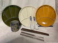 Front view showing all plates, cup, spoons and chopsticks