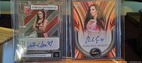 Fronts of both autographed WWE trading cards