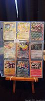 Full sheet showing 9 foil Pokémon cards in binder page